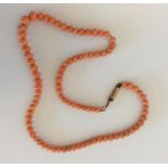 A small graduated string of coral beads with barre