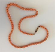 A small graduated string of coral beads with barre