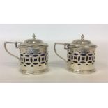 A pair of Edwardian silver pierced mustards with h