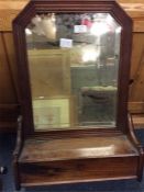 A mahogany mounted toilet mirror.