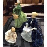 Three Royal Doulton figurines.