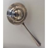 An Art Deco silver tea strainer of circular form.