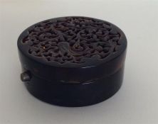 A carved tortoiseshell box with silver hinge and t