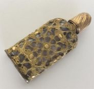 An unusual 18th Century gilt overlaid scent bottle