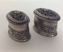 A pair of good oval silver Indian boxes profusely