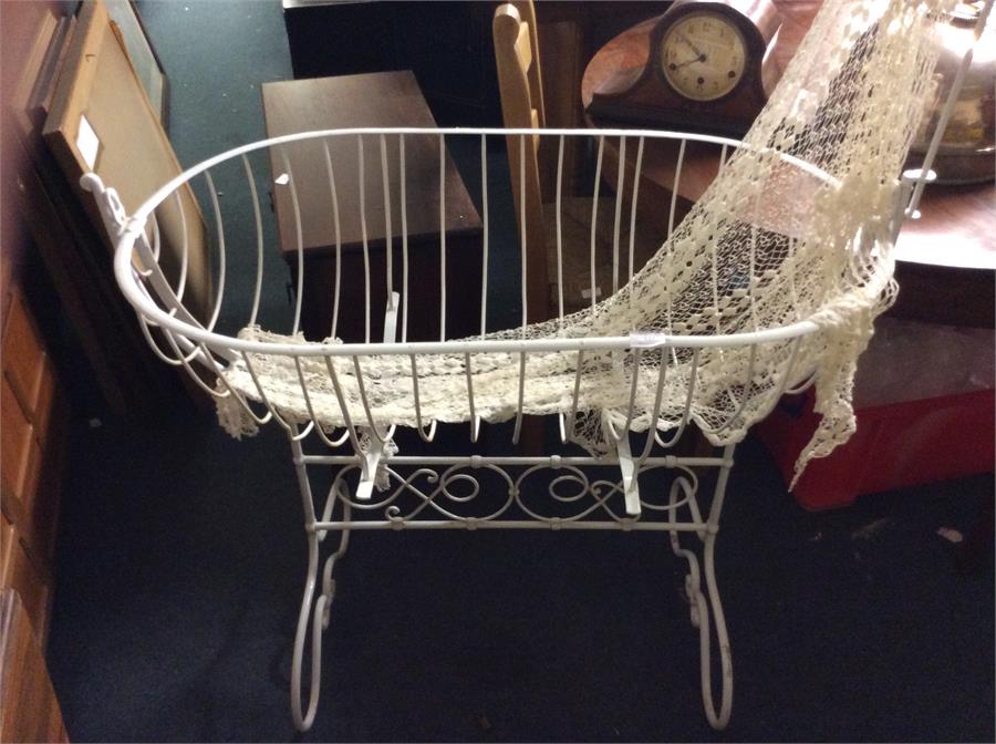 A wrought iron swinging cot.