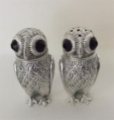 A pair of heavy silver owls in the form of salts w