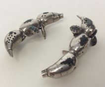 A pair of unusual Chinese silver peppers with leaf