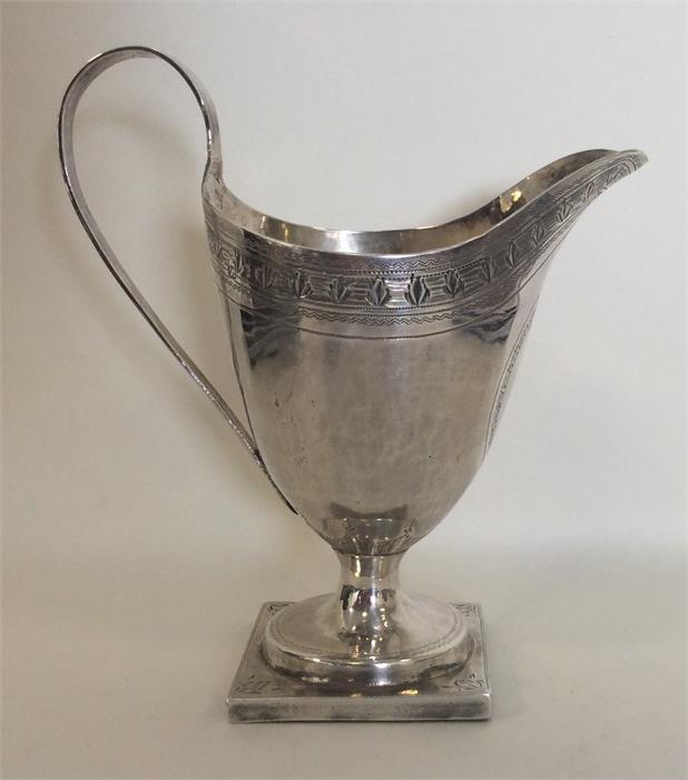 A Georgian silver helmet shaped cream jug attracti - Image 2 of 2