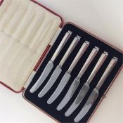 A boxed set of silver handled tea knives with stai