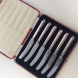 A boxed set of silver handled tea knives with stai