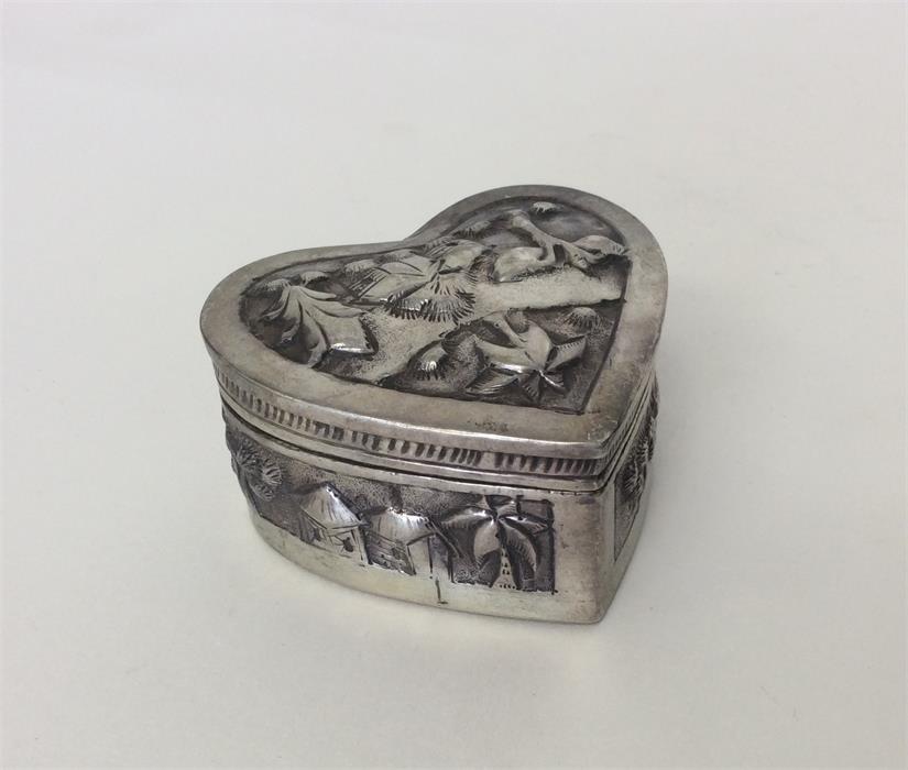 An Indian heart shaped silver box with lift-off co