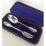 A boxed two piece silver christening set decorated