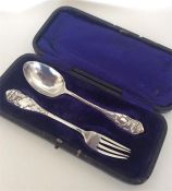 A boxed two piece silver christening set decorated