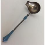 A Russian silver gilt and enamelled pouring spoon