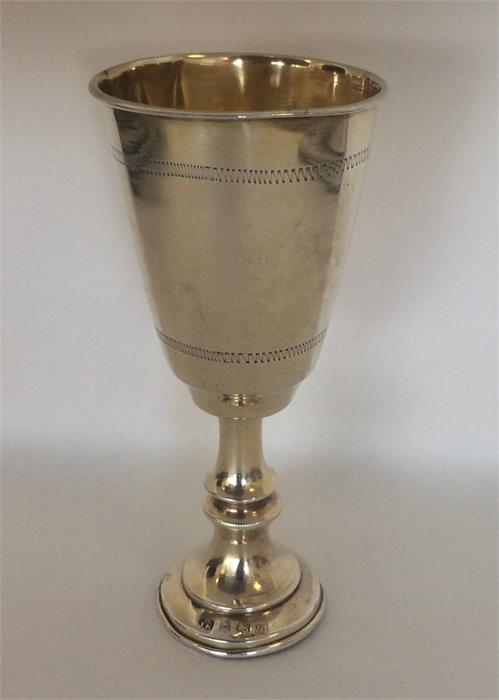 A small silver gilt tapering goblet with engraved