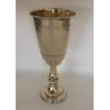 A small silver gilt tapering goblet with engraved