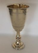 A small silver gilt tapering goblet with engraved