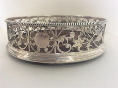 A Georgian silver wine coaster with pierced galler