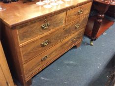 A mahogany flat front chest of drawers.