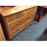 A mahogany flat front chest of drawers.