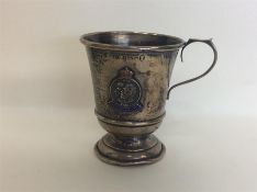 A small tapering silver christening cup with ename