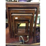 A set of four Oriental carved tables.