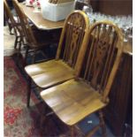 An oak dresser, four chairs and a table.