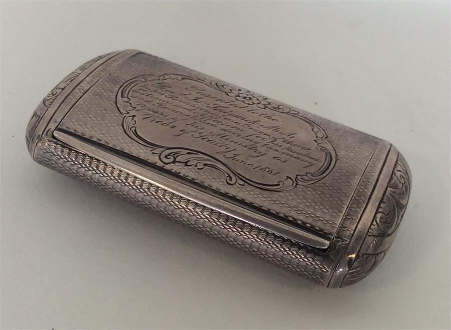 A heavy Victorian silver snuff box decorated with