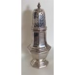 A Georgian style silver caster with lift-off cover