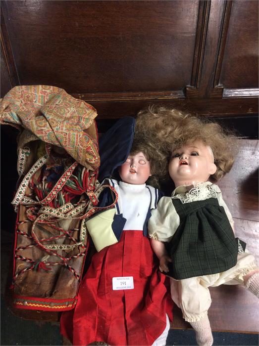 Two old dolls together with a papoose.