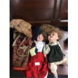 Two old dolls together with a papoose.