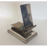 A novelty silver notepad on square base with hinge