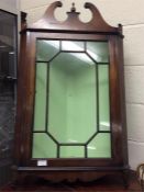 A reproduction mahogany corner cupboard.