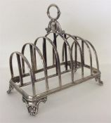 A large heavy Victorian toast rack with leaf decor