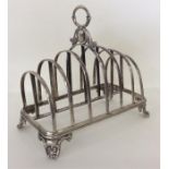 A large heavy Victorian toast rack with leaf decor