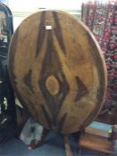 An Edwardian walnut inlaid pedestal table.