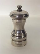 A plain tapering silver pepper grinder. London. By