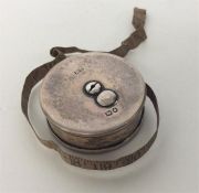 A novelty circular silver tape measure. London. By