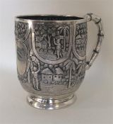 A good quality Indian silver mug decorated with fi