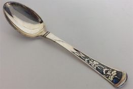 A stylish silver and niello spoon decorated with f