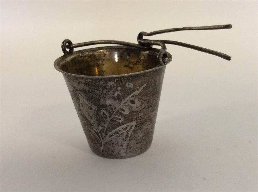 A Russian silver and silver gilt tea strainer with