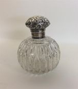 A silver mounted embossed top scent bottle with sc