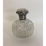 A silver mounted embossed top scent bottle with sc