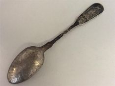A small Russian teaspoon engraved with flowers and