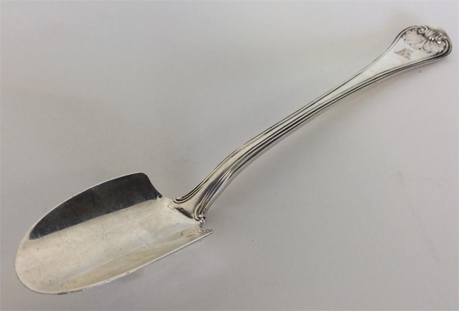 A heavy silver stilton scoop with shell terminal.