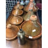 Seven various sized terracotta tagines.