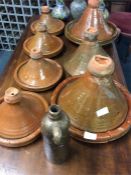 Seven various sized terracotta tagines.