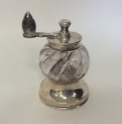 A good quality silver mounted and glass pepper gri