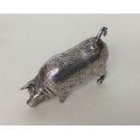 A heavy novelty silver figure of a pig with textur